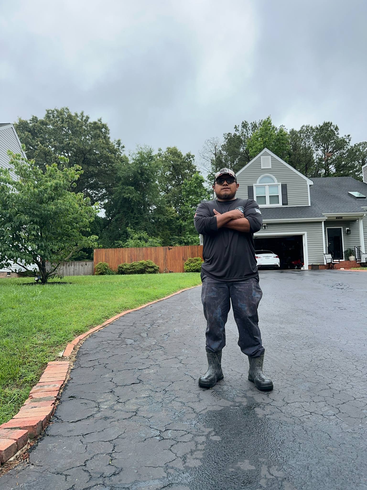 Exterior cleaning professional working on a driveway